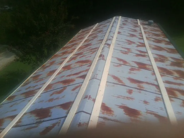 Rusted metal roof panels with new wood purlins before replacement — Storm Damage Roof Repair in Chesnee by Roofing Brothers