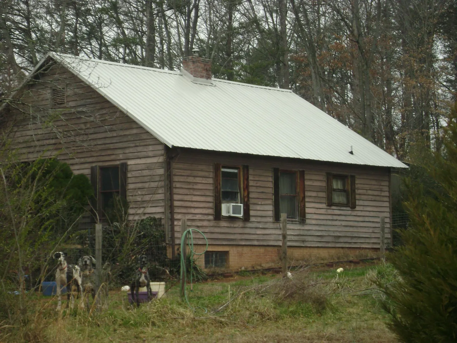 White metal roof on an old wood sided farmhouse, from a Metal Roof Installation job in Chesnee